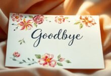 Farewell in Style: Themed Office Goodbye Card for Coworker 8 A Goodbye card with the word 'Goodbye' written in elegant cursive script. The card is decorated with colorful floral illustrations and placed on soft, peach-colored fabric with gentle folds.